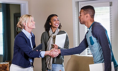Young couple meet with a social worker for their home study visit